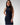 Model wearing the Sonora metallic silver lizard, luxury Apple Watch band wearing a long navy dress.