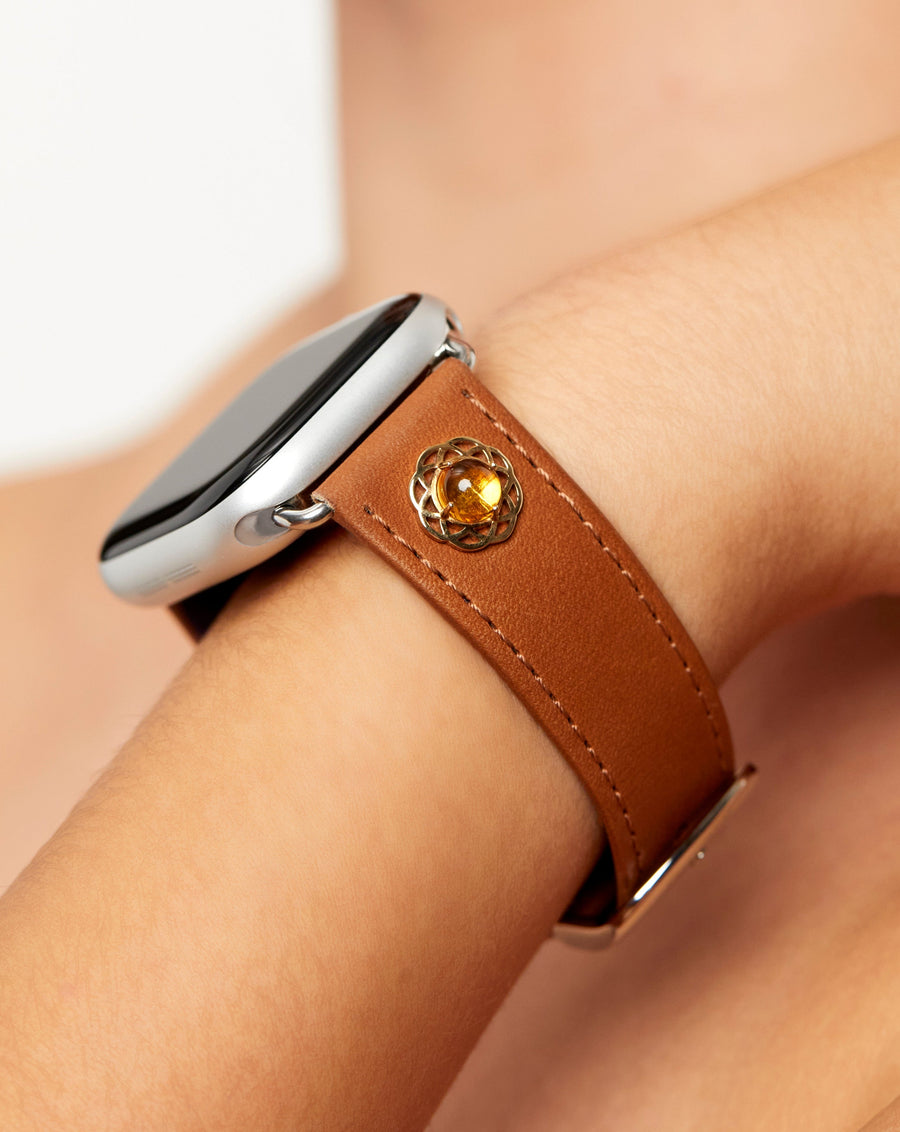 Calafate in brown leather with citrine cabochon set in a 14k yellow gold flower design, luxury Apple Watch band on model