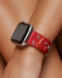 Chalonne Confetto in red leather studded with 14k yellow and white gold bars, luxury Apple Watch band on model 