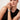 A close-up of a model wearing the Etoile Apple Watch band by Chalonne with a black sleeveless top.