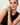 A close-up of a model wearing the Etoile Apple Watch band by Chalonne with a black sleeveless top.