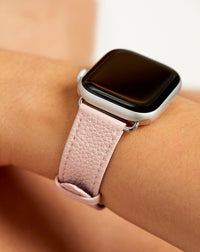 Pink Apple Watch band on model against neutral background