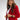 Liquid in red shiny patent leather luxury Apple Watch band on model wearing red blazer and white pants 
