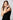 Model wearing the Orleans in rose luxury alligator Apple Watch band with a sleek black dress on white background