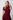 Woman wearing a burgundy dress and the Sorrento in peacock luxury Apple Watch band by Chalonne against a plain background
