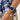 Model wearing the Orleans in Azure luxury Apple Watch band with a blue floral dress.