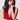 A woman with dark hair wearing the Orleans in Fuchsia Apple Watch band with a low cut red dress.