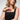 A woman wearing the Sedona in Black Apple Watch band and a black sleeveless dress.