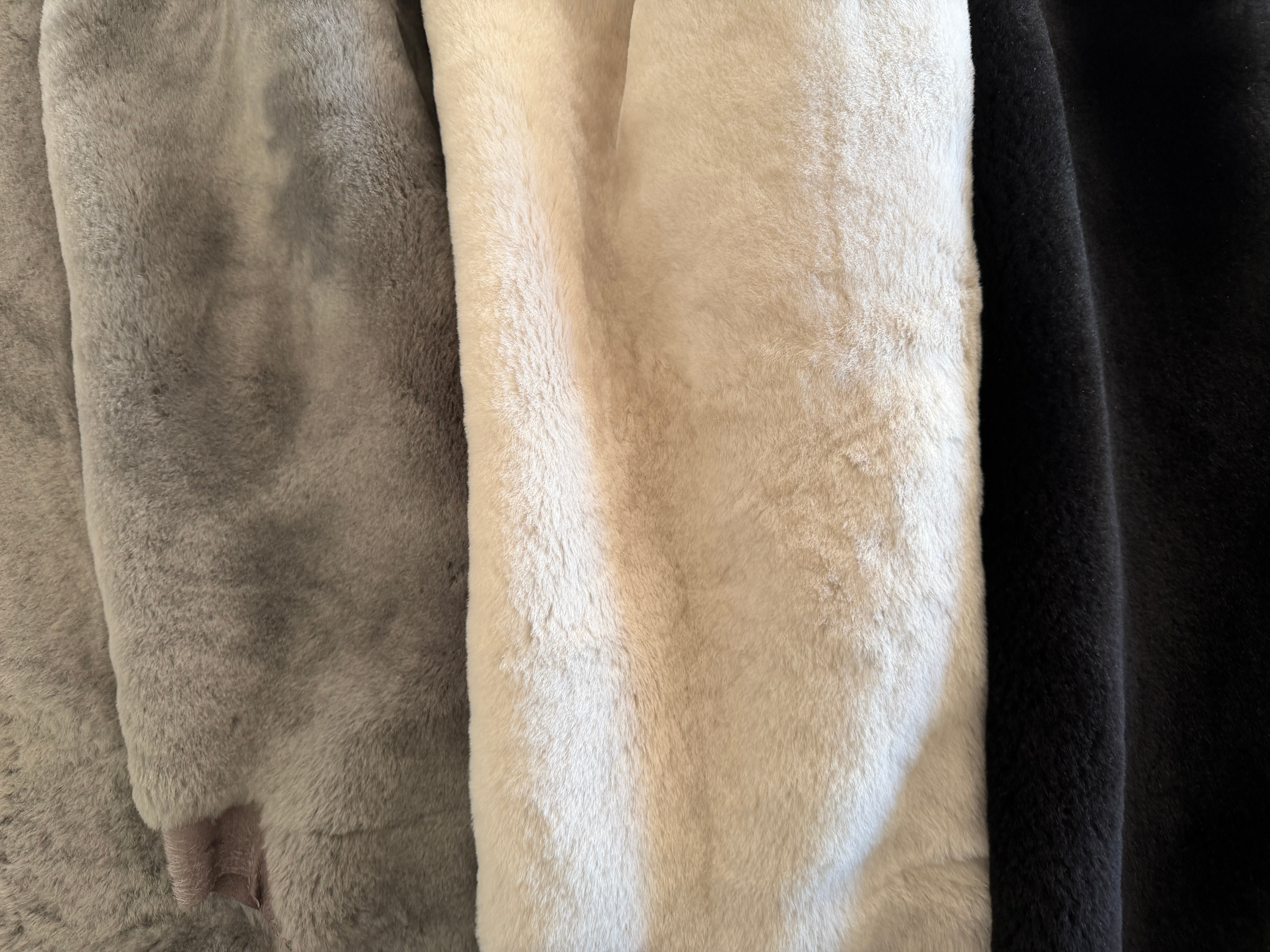 Close-up of shearling leather in taupe, cream and black colorways