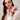 Model wearing the Sorrento in Chocolate luxury Apple Watch band with a cream blouse and brown pants