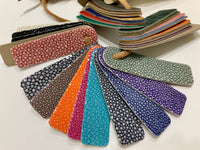 Collection of colorful textured pouches on a white background