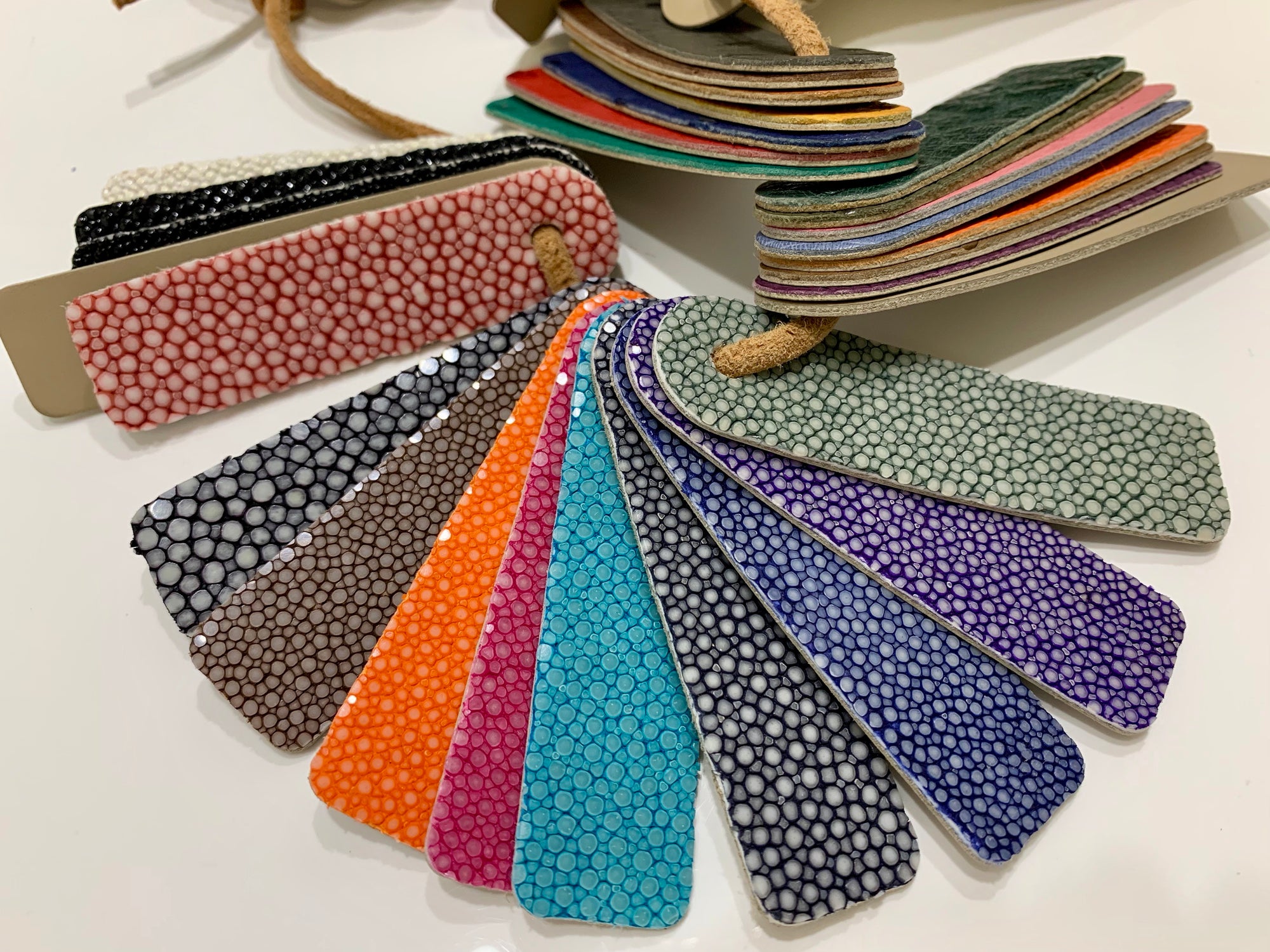 Collection of colorful textured pouches on a white background